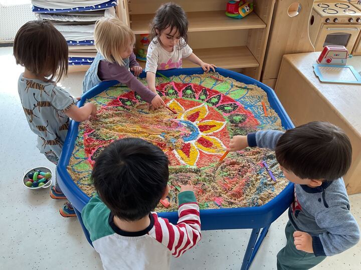 Children creating rangoli pattern as a part of indian cultural activities